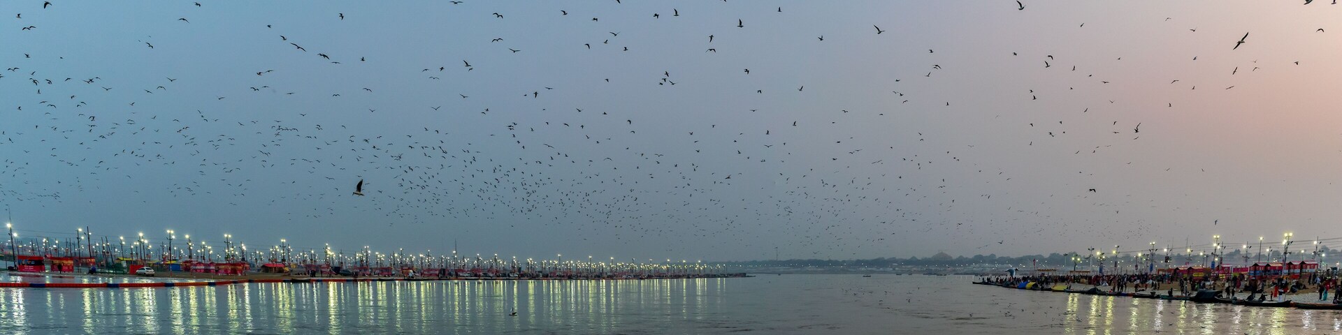 Kumbha Mela, Allahabad, Uttar Pradesh, India; 17-Feb-2019; lights on the river banks, sunset at Sangam, river Ganges