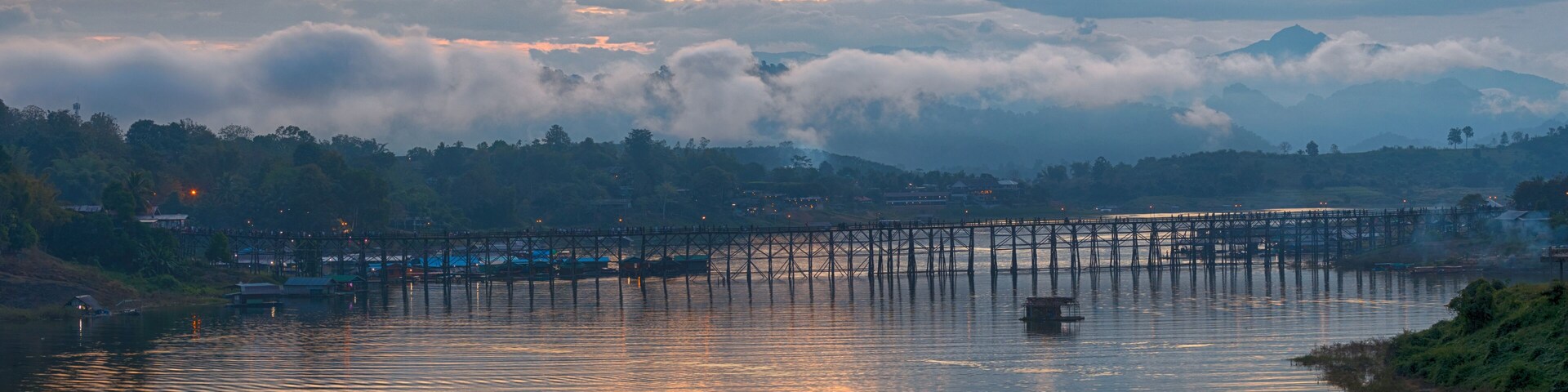 Panorama of beautiful sunrise scene at old an long wooden bridge at Sangklaburi,Kanchanaburi province, Thailand