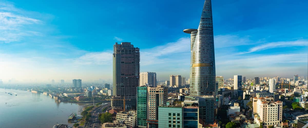 A cityscape with two prominent skyscrapers, a river, and a dense urban environment.