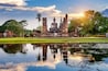 Buddha statue and Wat Mahathat Temple in the precinct of Sukhothai Historical Park, Wat Mahathat Temple is UNESCO World Heritage Site, Thailand.