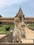 A temple entrance with intricate carvings and a statue of an elephant.