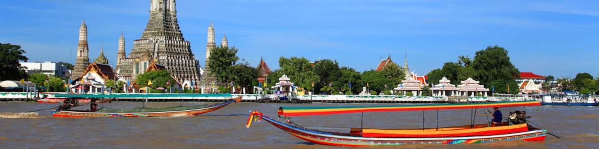 Long tail motor boat cruise in front of Wat Arun in Chaopraya river