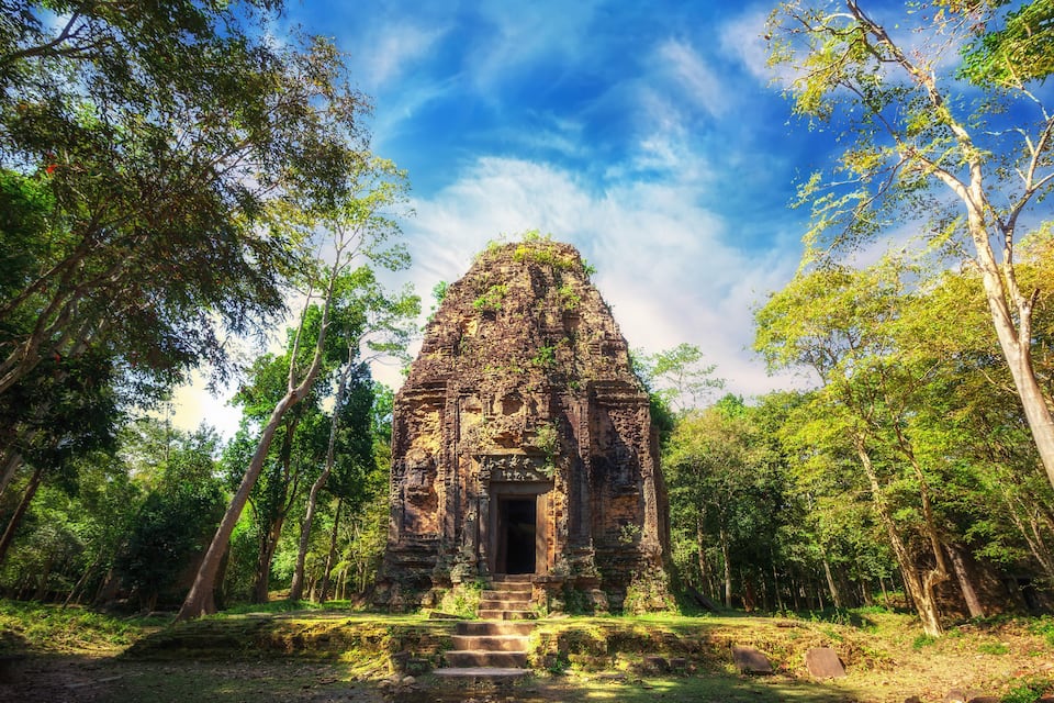A temple surrounded by lush greenery and trees.