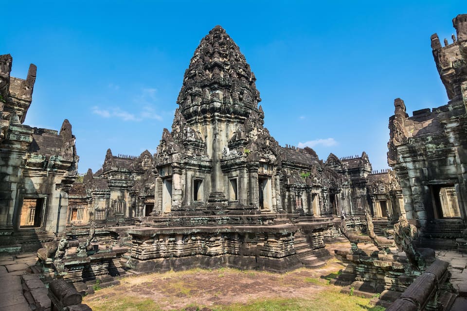 An ancient temple with intricate carvings and a central tower.