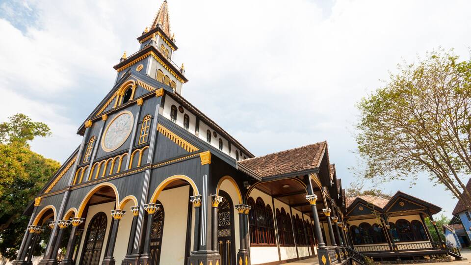 A historic building with ornate architecture, including a clock tower, arched windows, and decorative columns.