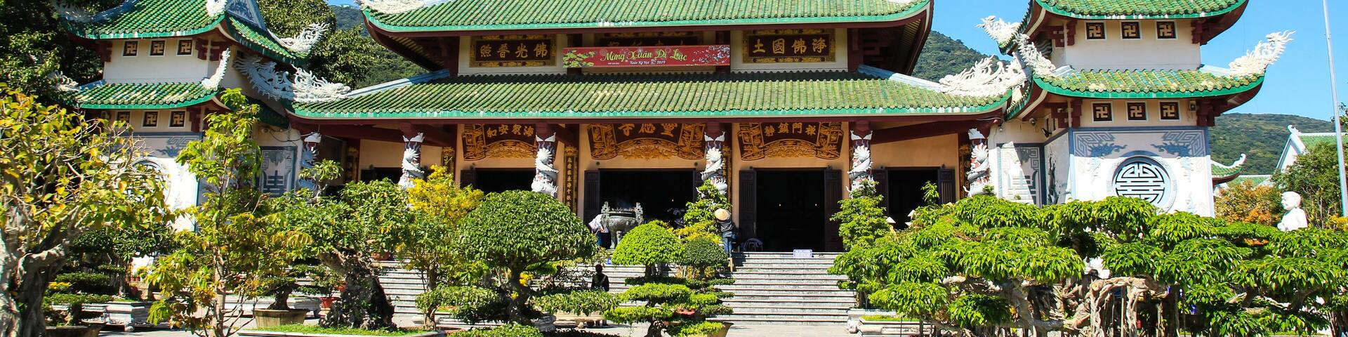 A traditional Chinese temple with ornate architecture, including green roofs and intricate designs.