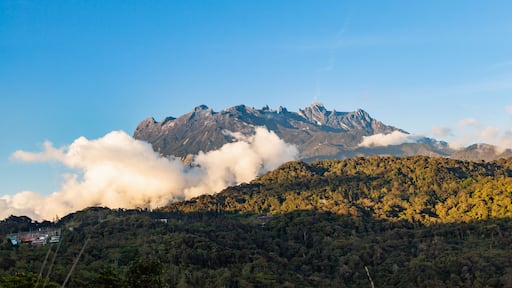 view of Mount Kinabalu emerges out from the clouds at near sunsets