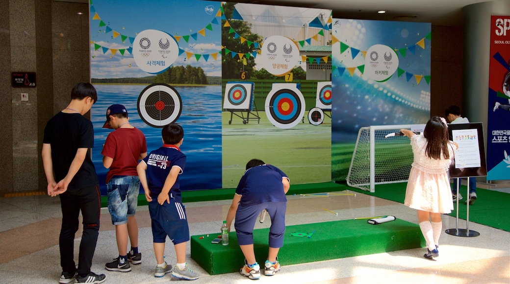 Seoul Olympic Museum featuring interior views and signage as well as a small group of people