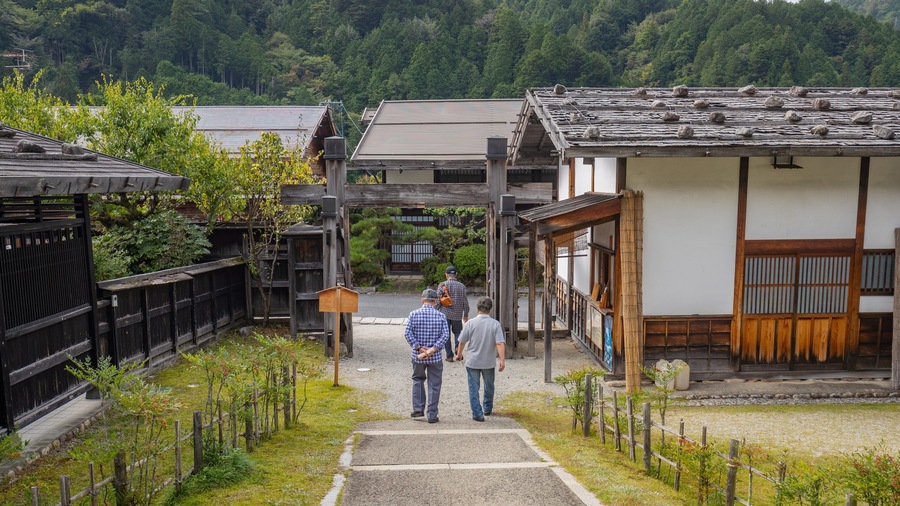 Tsumago Honjin featuring a small town or village as well as a small group of people