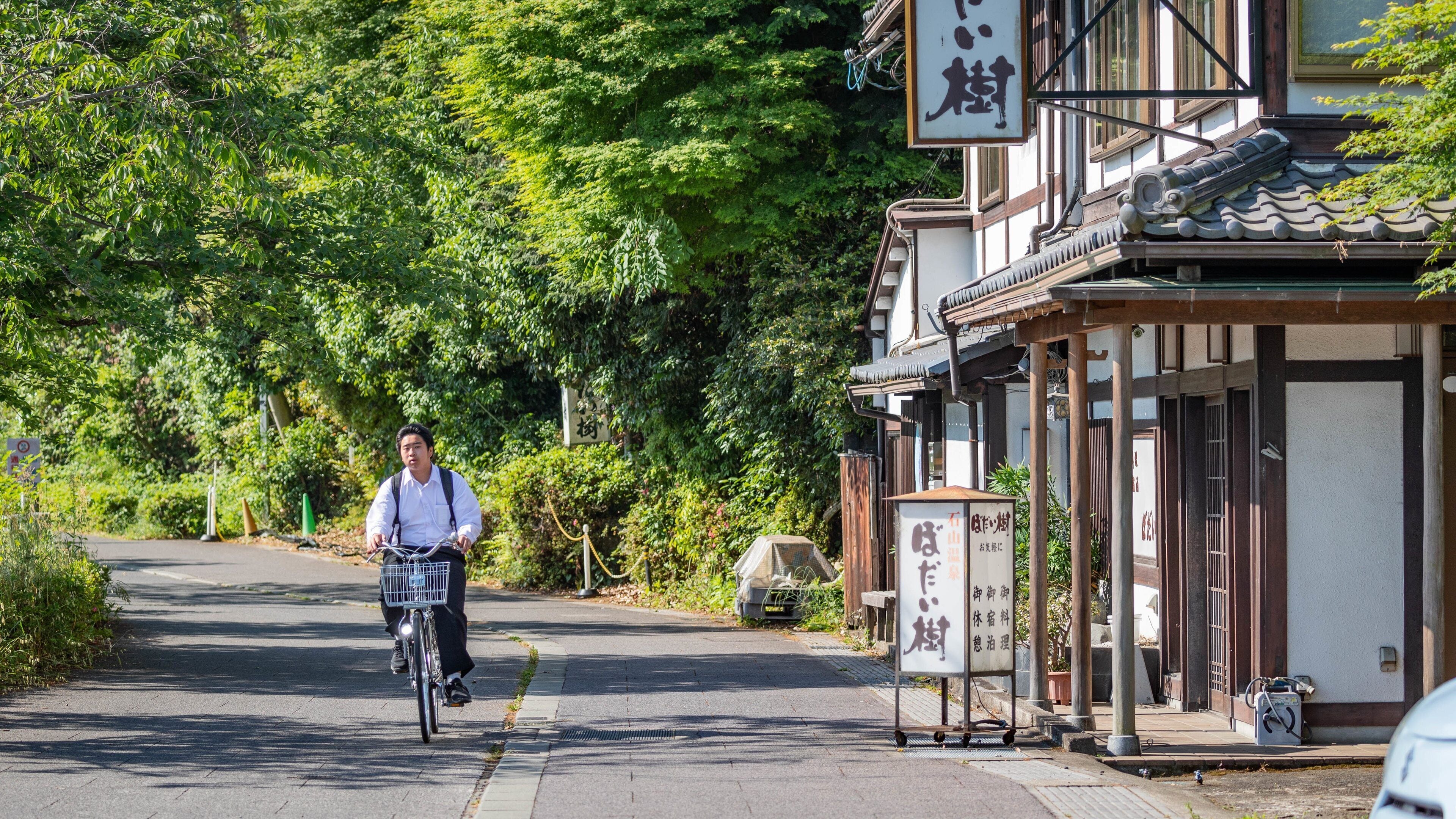 Ishiyama-dera showing cycling and a small town or village as well as an individual male
