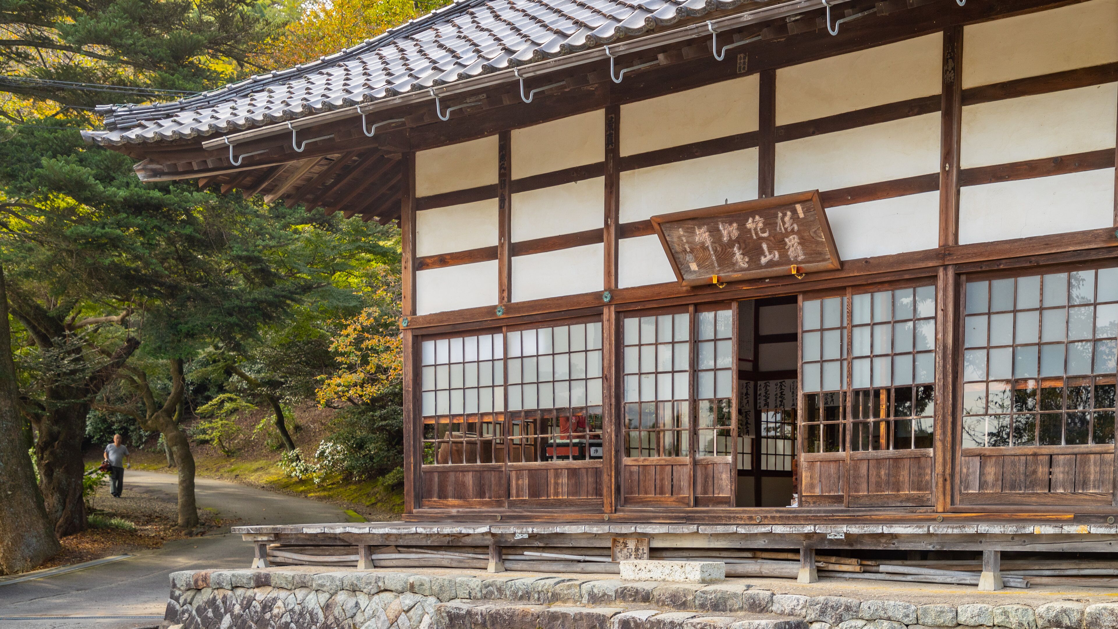 A traditional Japanese building with a tiled roof and wooden lattice windows.