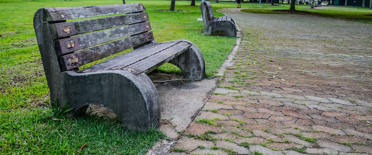 Old style stone park benches in a beach in Pasir Ris Singapore