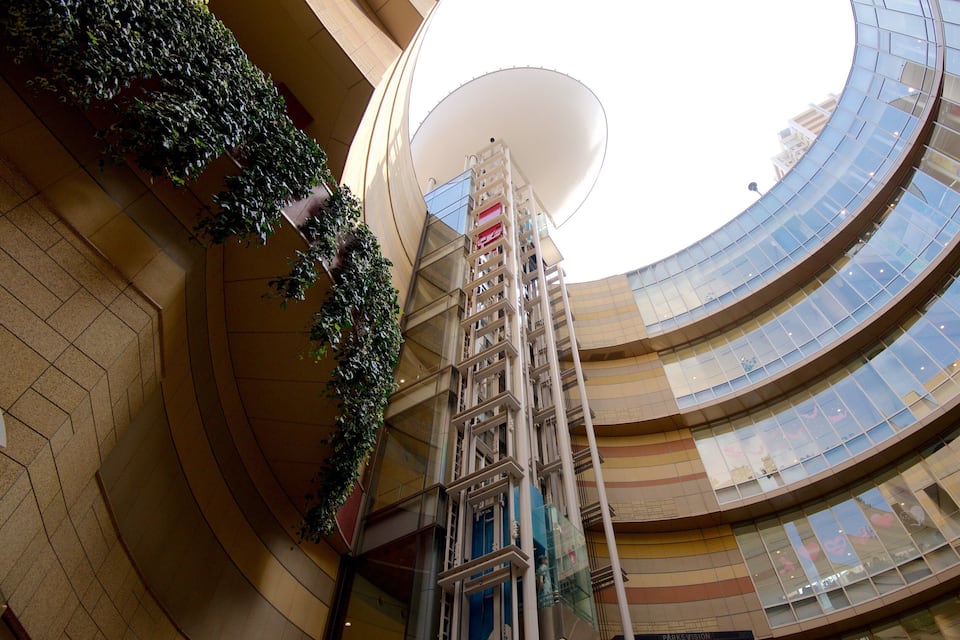 A modern building with curved glass windows and a central atrium.
