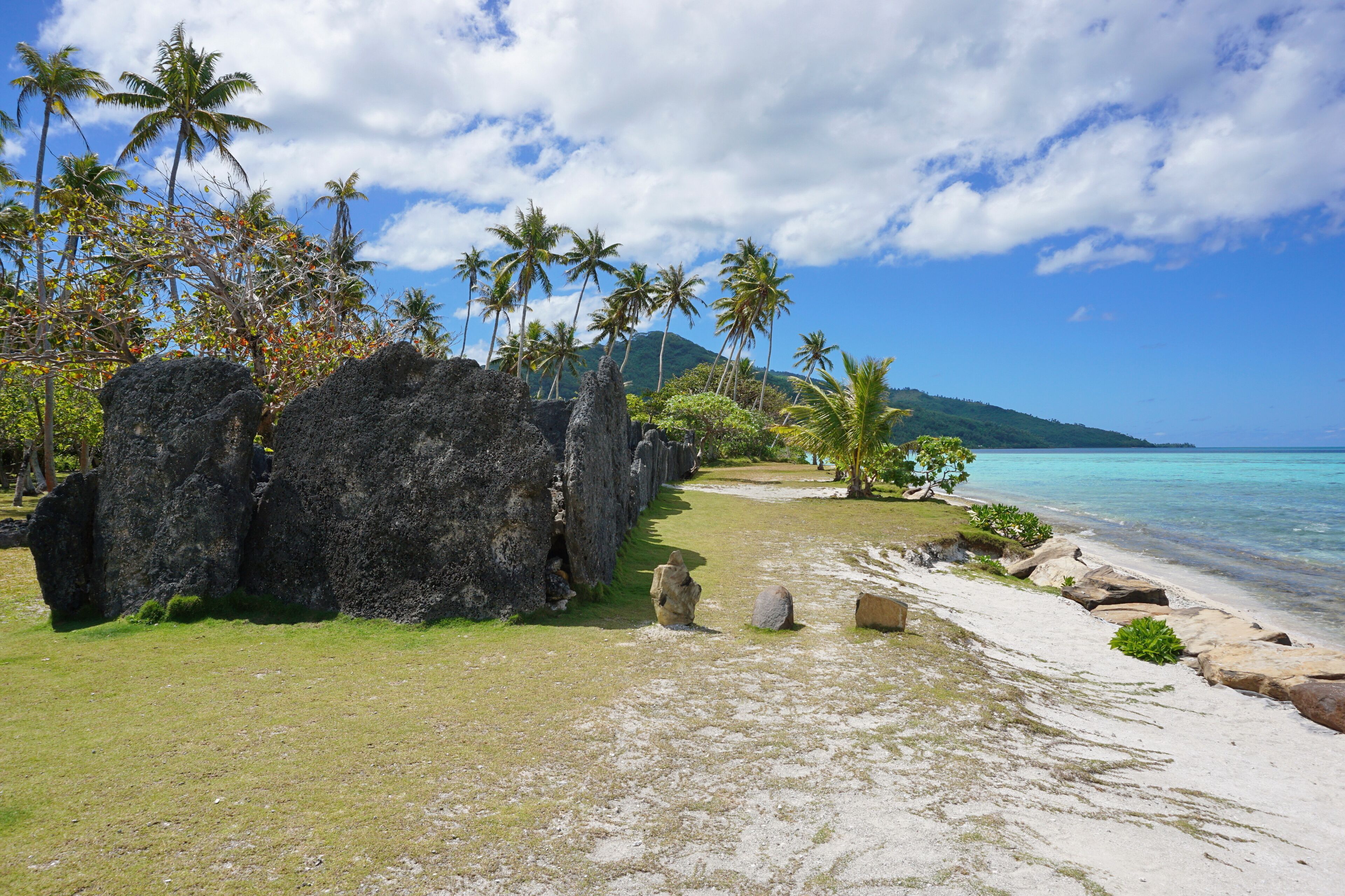 Tropical shore with ancient stone structure, the marae Anini on the south of the island of Huahine Iti, French Polynesia
