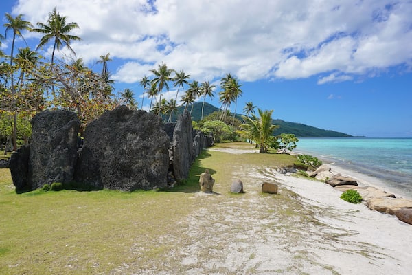 Tropical shore with ancient stone structure, the marae Anini on the south of the island of Huahine Iti, French Polynesia