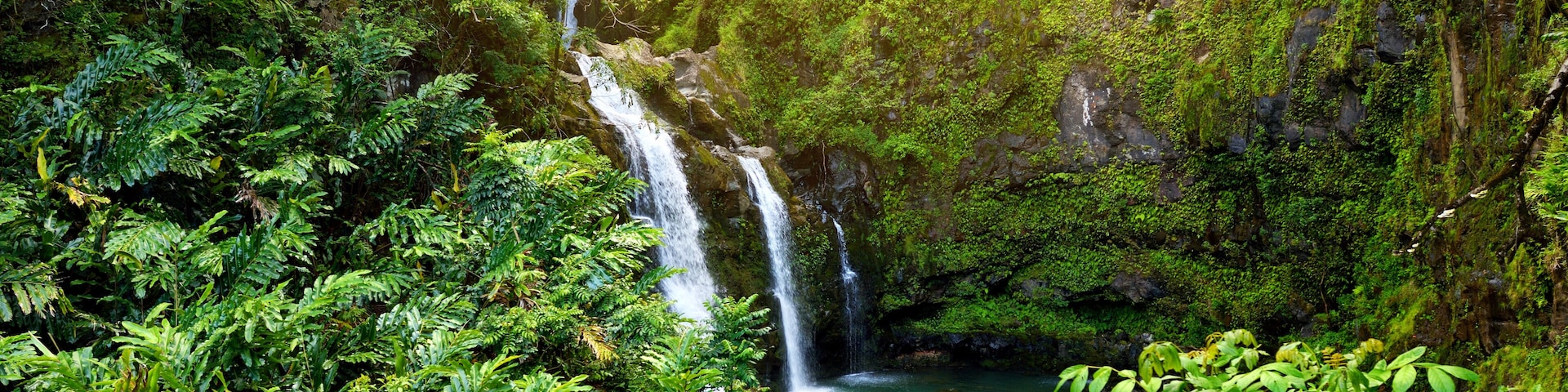 Upper Waikani Falls also known as Three Bears, a trio of large waterfalls amid rocks & lush vegetation with a popular swimming hole, off the Road to Hana Highway, Maui, Hawaii