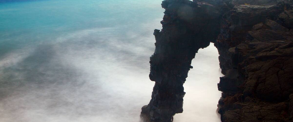 Holei Sea Arch which includes rugged coastline and general coastal views