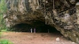 Maniniholo Dry Cave which includes caves and caving as well as a small group of people