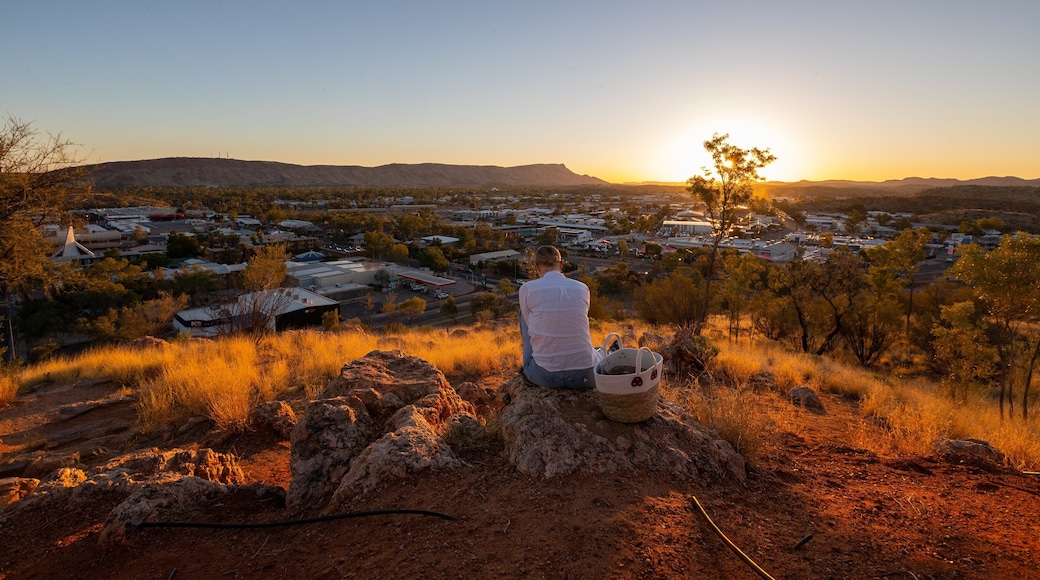 Anzac Hill showing a sunset, desert views and a small town or village