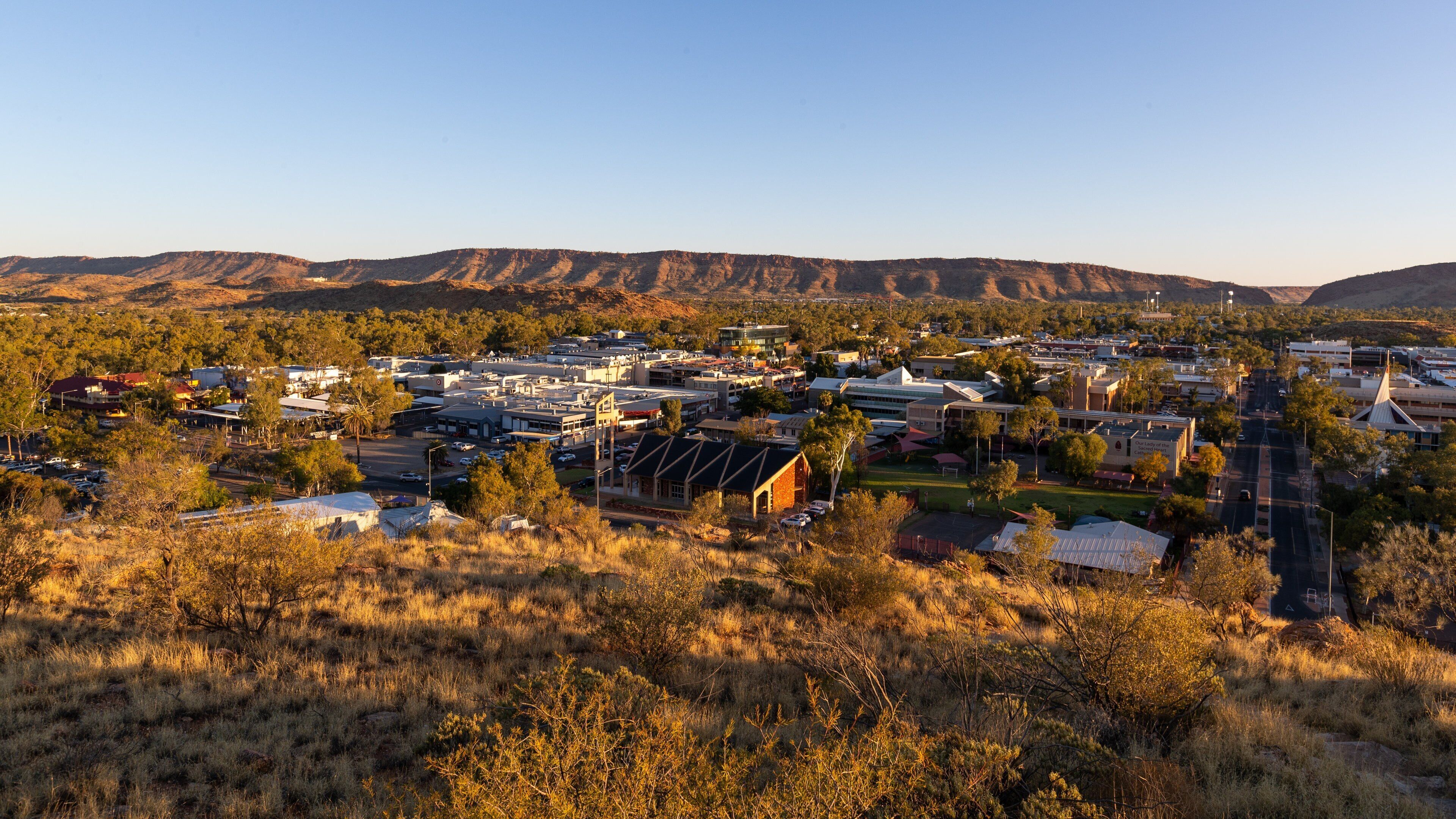 Anzac Hill showing a sunset, landscape views and a small town or village