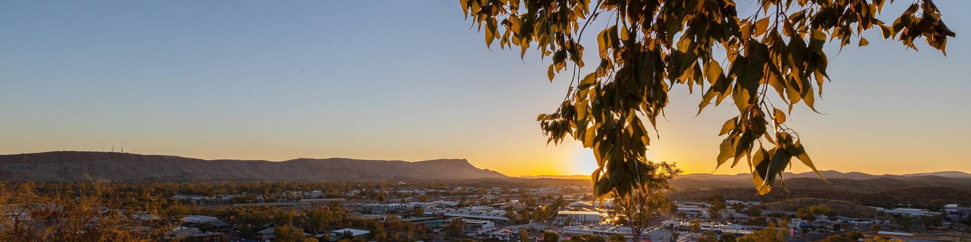 Anzac Hill showing landscape views, a small town or village and a sunset