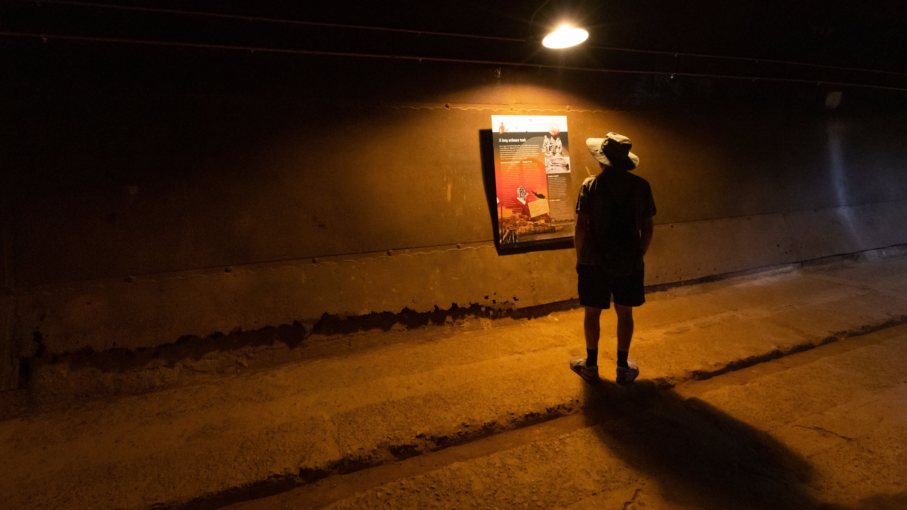 WWII Oil Storage Tunnels which includes interior views and signage as well as an individual male