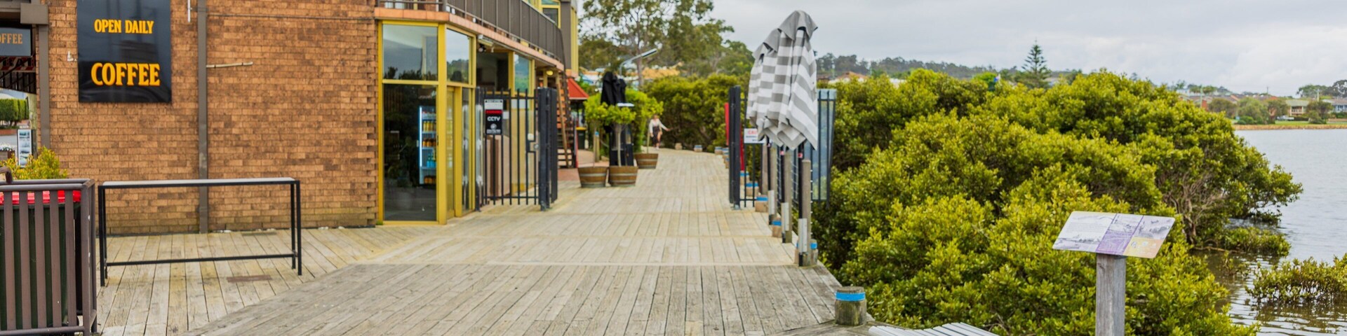 Merimbula Boardwalk featuring a small town or village and a bay or harbor