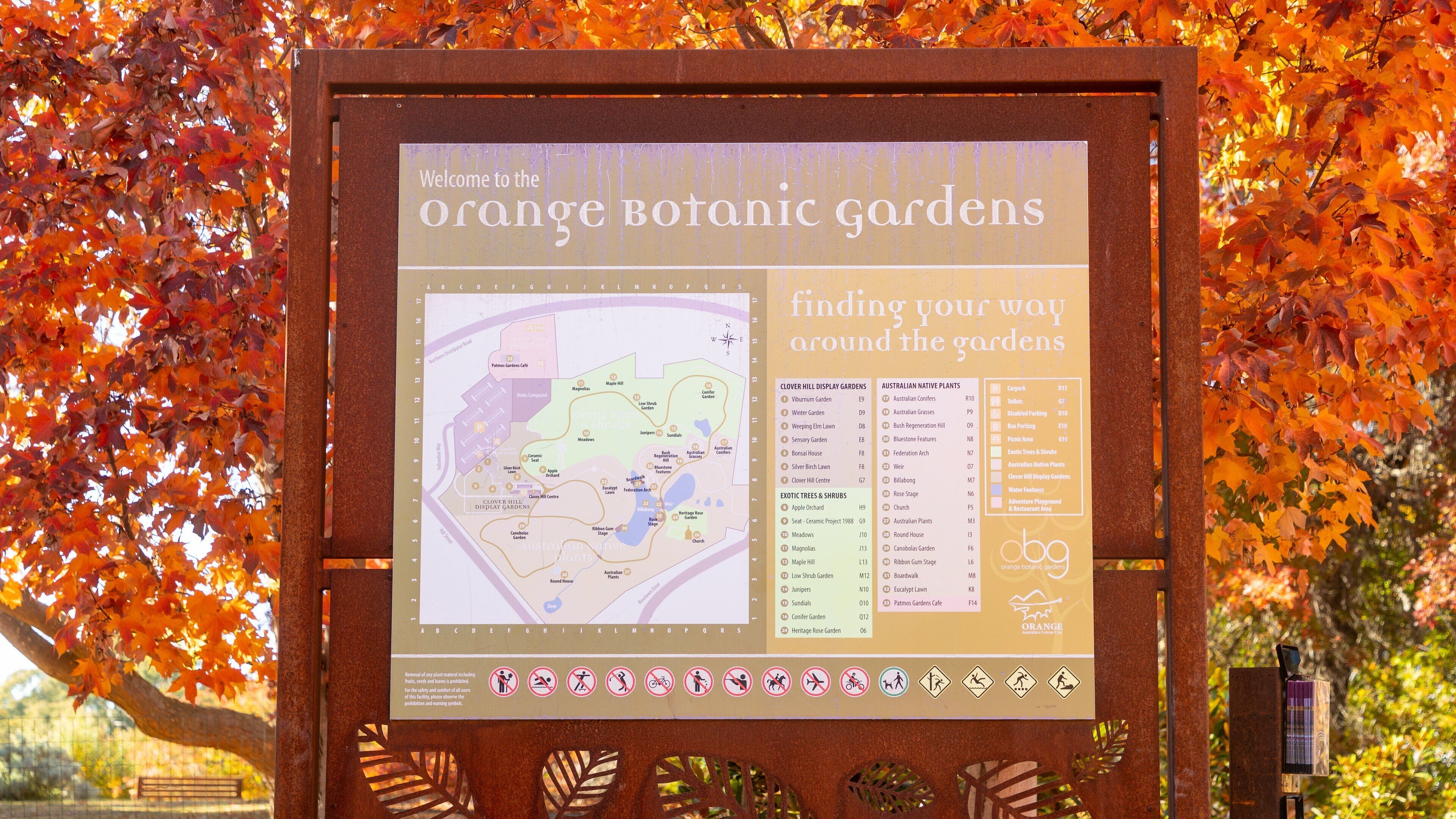 A signboard for Orange Botanic Gardens with a map and information about the gardens and facilities.