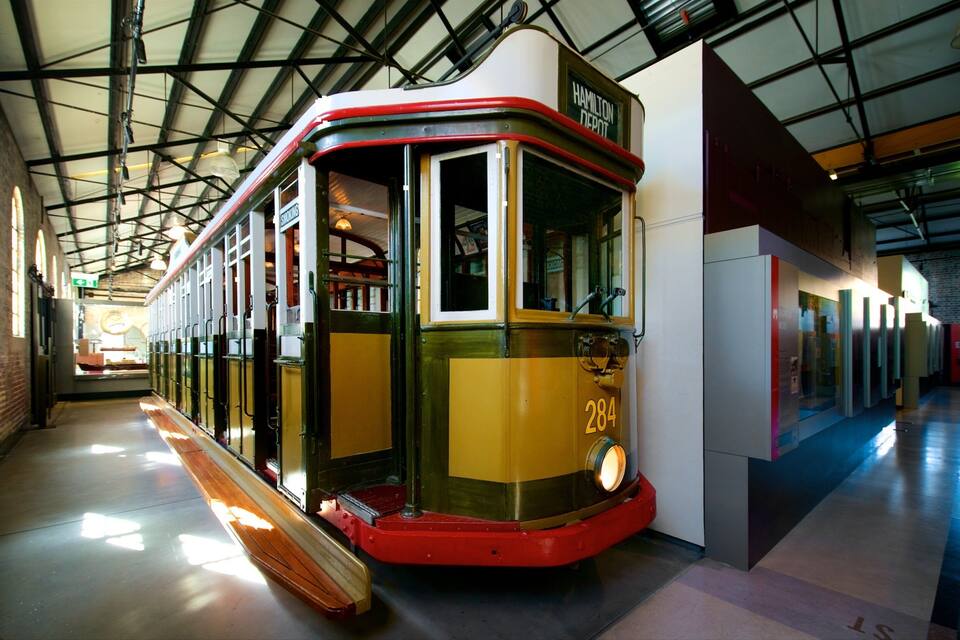 A vintage tram with the number 284 displayed on its front, parked inside a building with high ceilings and exposed beams.