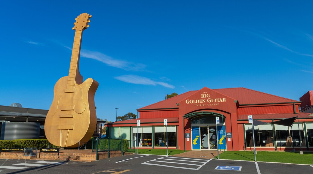 Big Golden Guitar Tourist Centre featuring signage and a monument