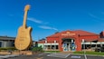 Big Golden Guitar Tourist Centre featuring signage and a monument