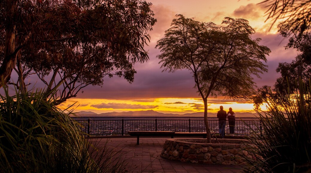 Oxley Scenic Lookout featuring a sunset and views as well as a couple