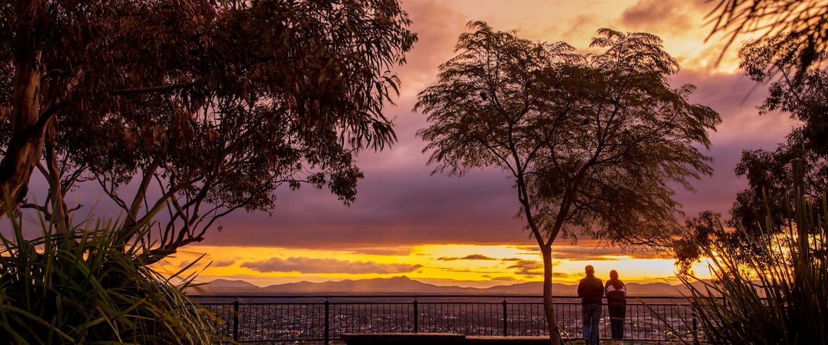 Oxley Scenic Lookout featuring a sunset and views as well as a couple
