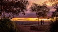 Oxley Scenic Lookout featuring a sunset and views as well as a couple