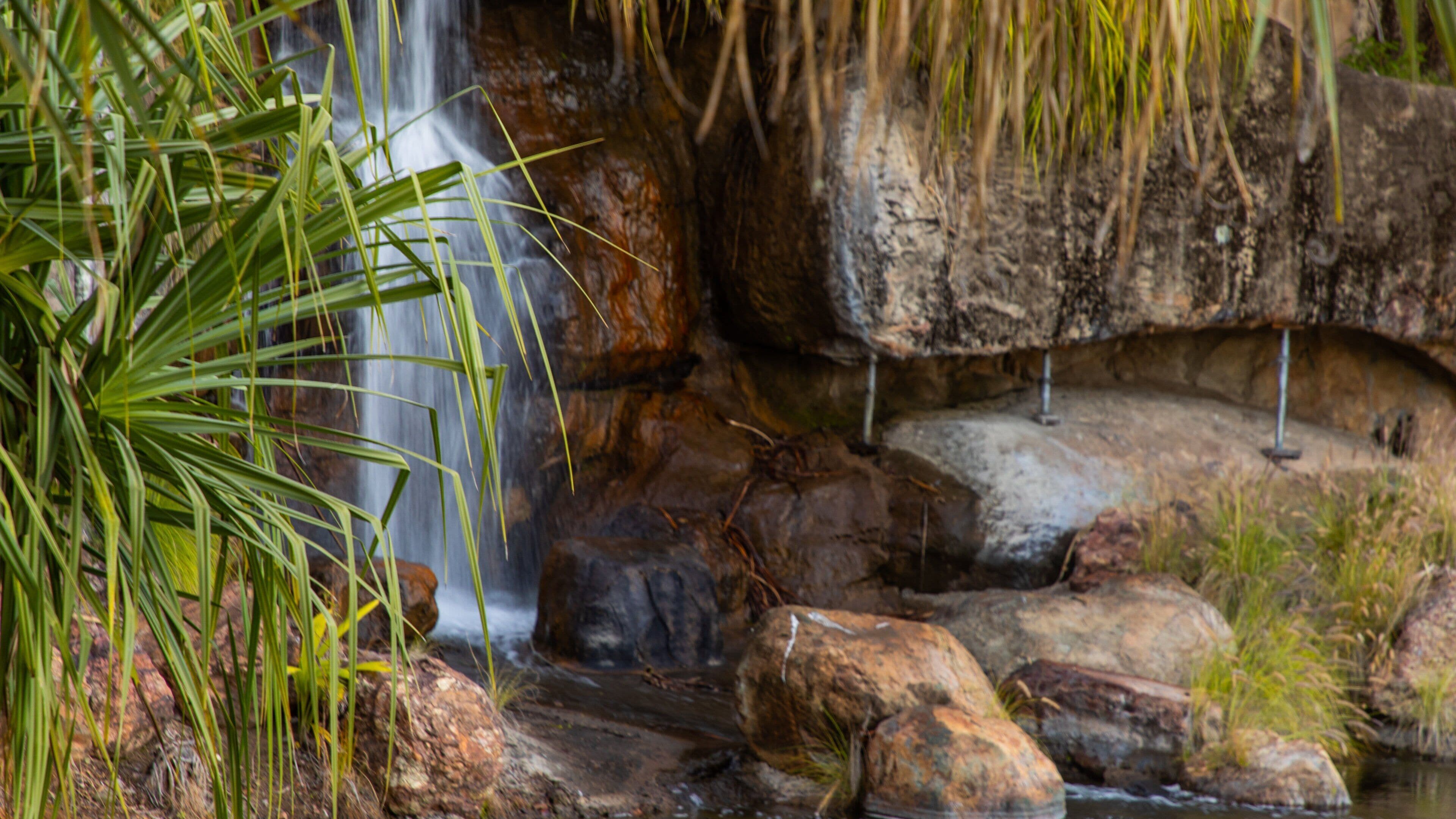 A waterfall cascading over rocks in a natural setting.