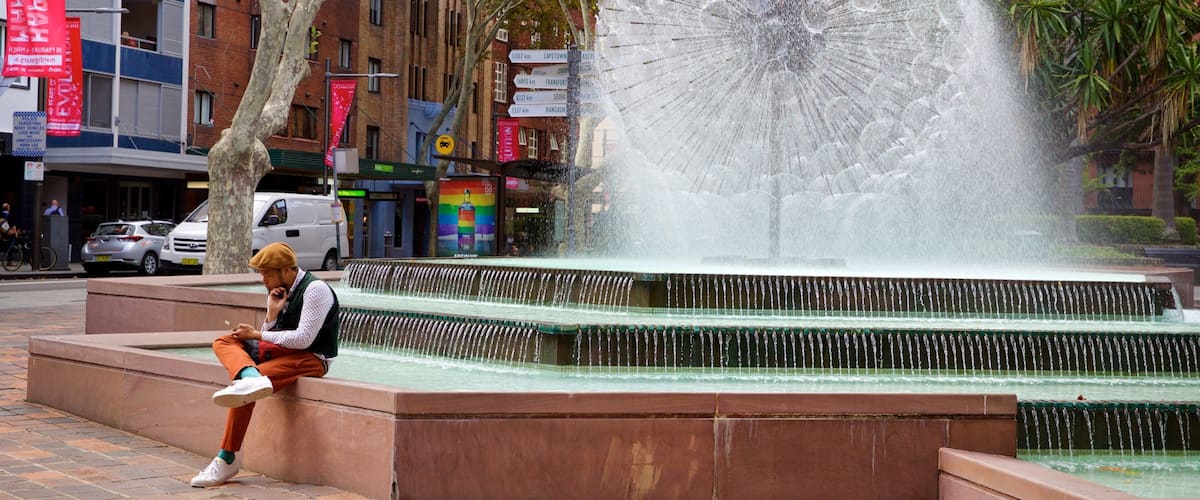 El Alamein Fountain featuring a fountain as well as an individual male