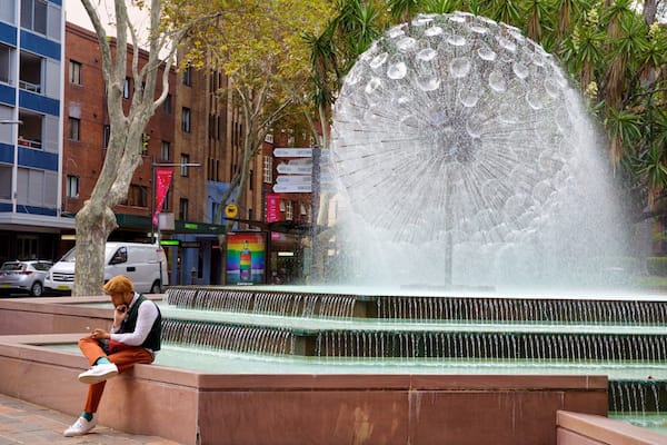 El Alamein Fountain featuring a fountain as well as an individual male