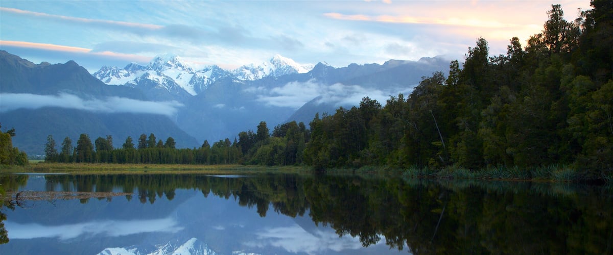 Fox Glacier which includes a lake or waterhole, a sunset and mountains