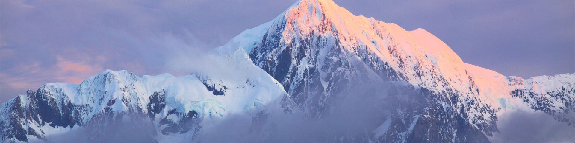 Fox Glacier featuring mountains and a sunset