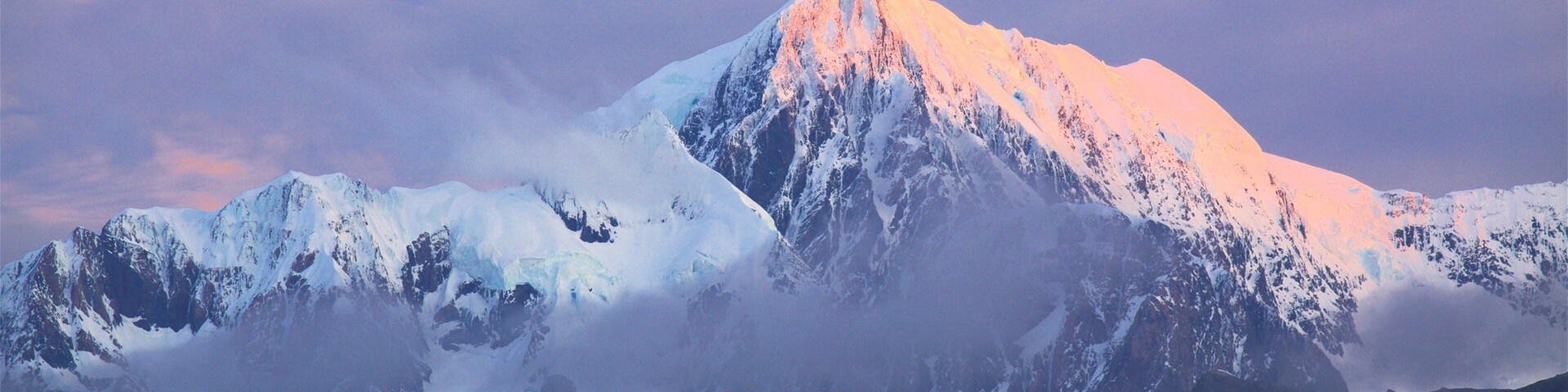 Fox Glacier que incluye montañas y una puesta de sol