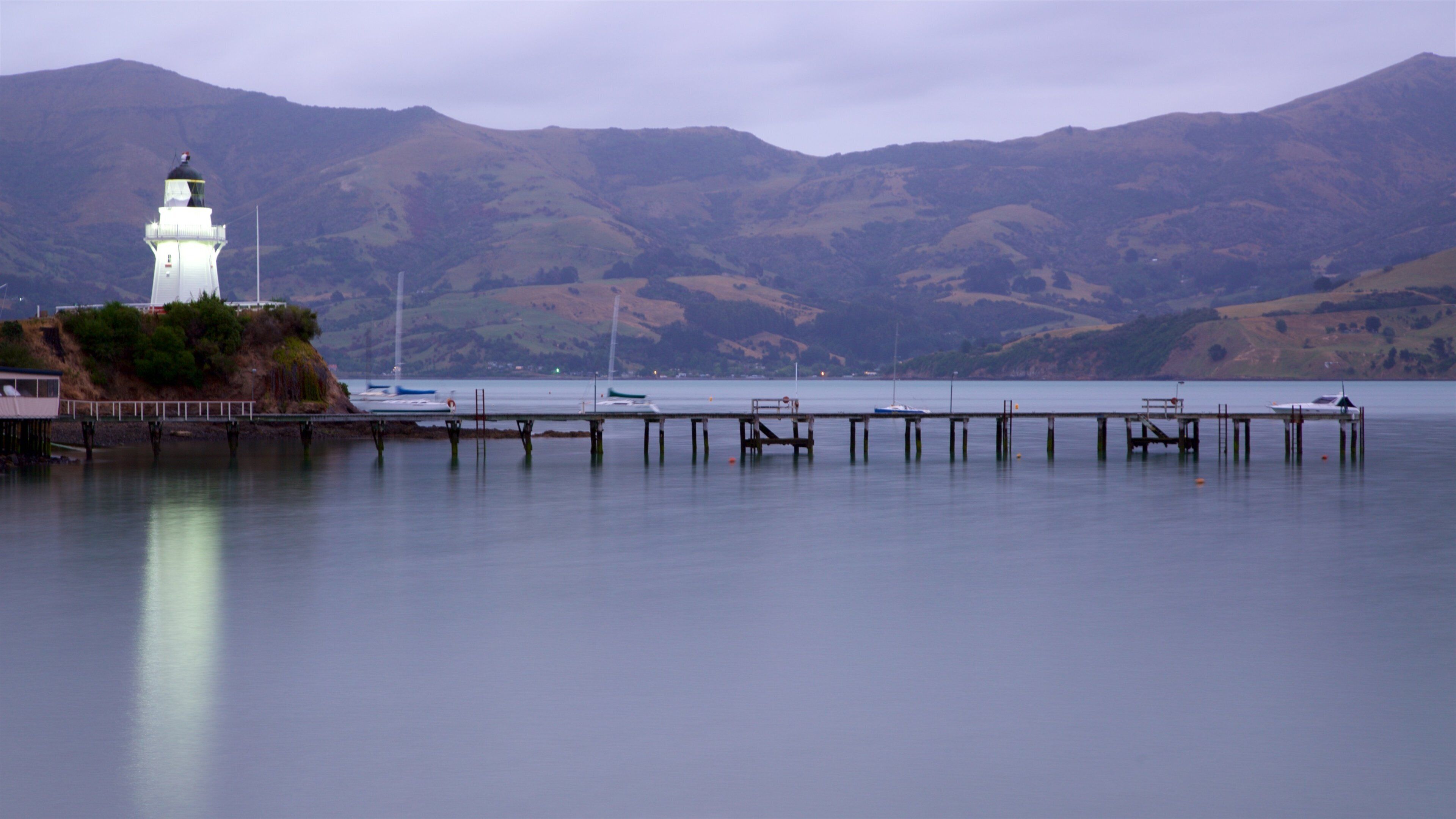 Akaroa Lighthouse which includes a lighthouse, tranquil scenes and a sunset