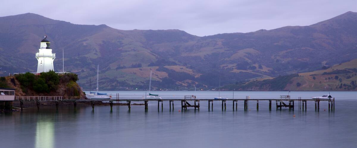Akaroa Lighthouse which includes a lighthouse, tranquil scenes and a sunset
