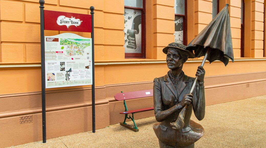 Mary Poppins Statue featuring signage and a statue or sculpture