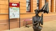 Mary Poppins Statue featuring signage and a statue or sculpture