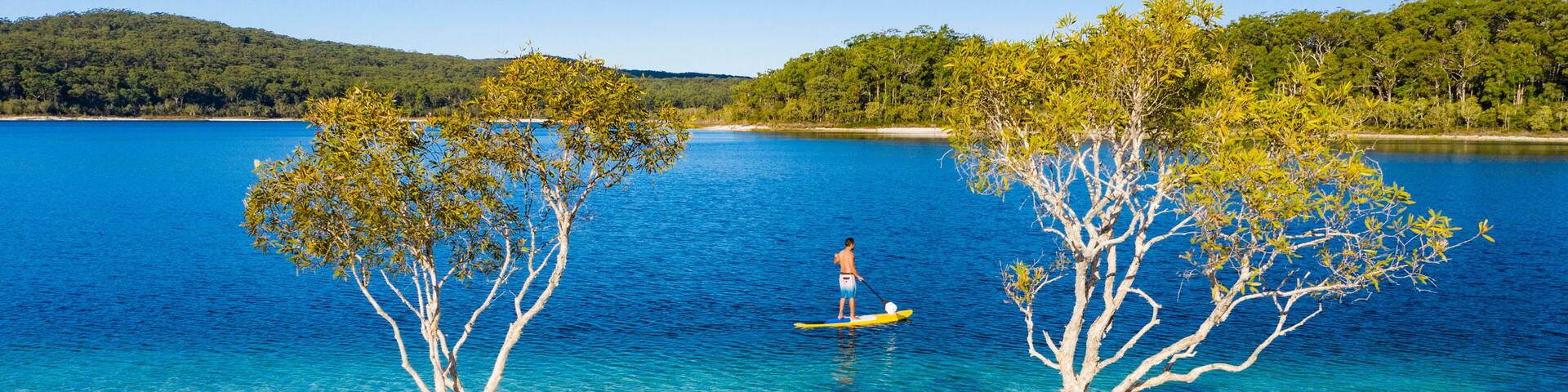 Stand up paddle boarding on Lake Mckenzie, Fraser Island