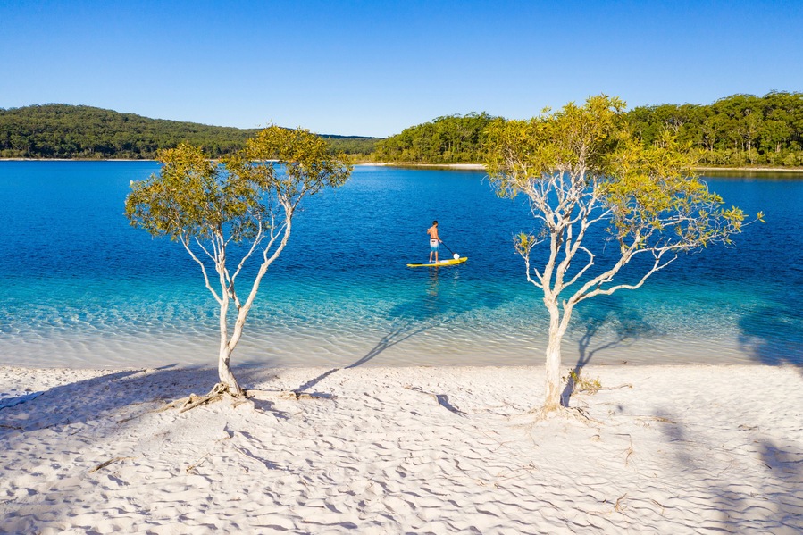 Stand up paddle boarding on Lake Mckenzie, Fraser Island