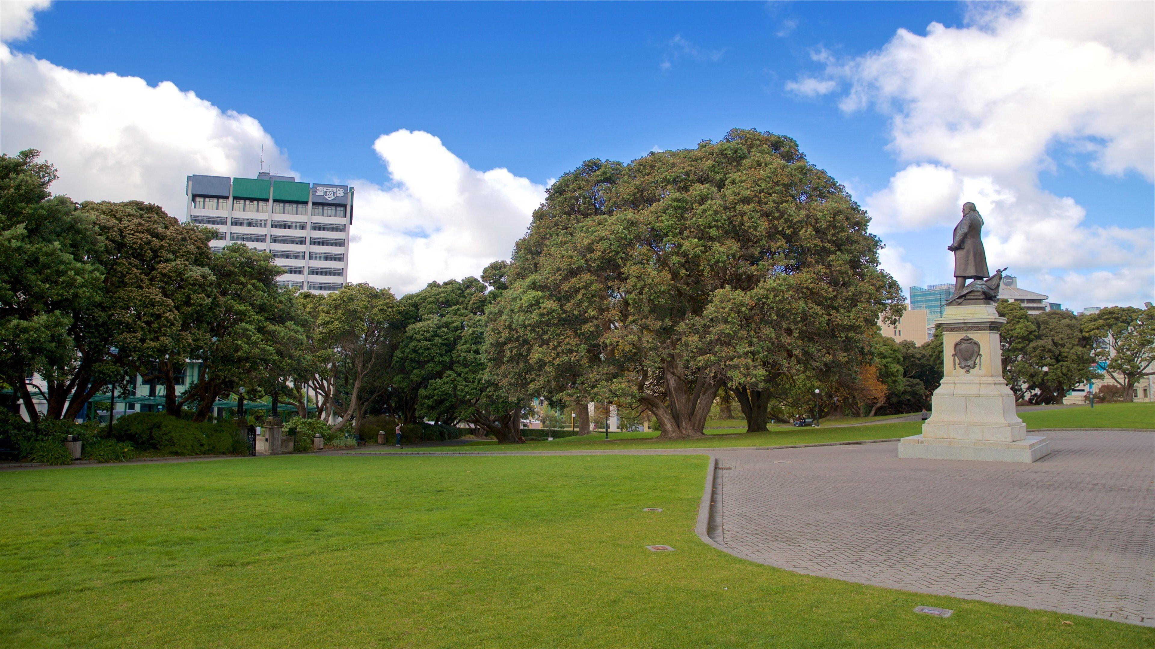 Parliament House featuring a garden and a statue or sculpture