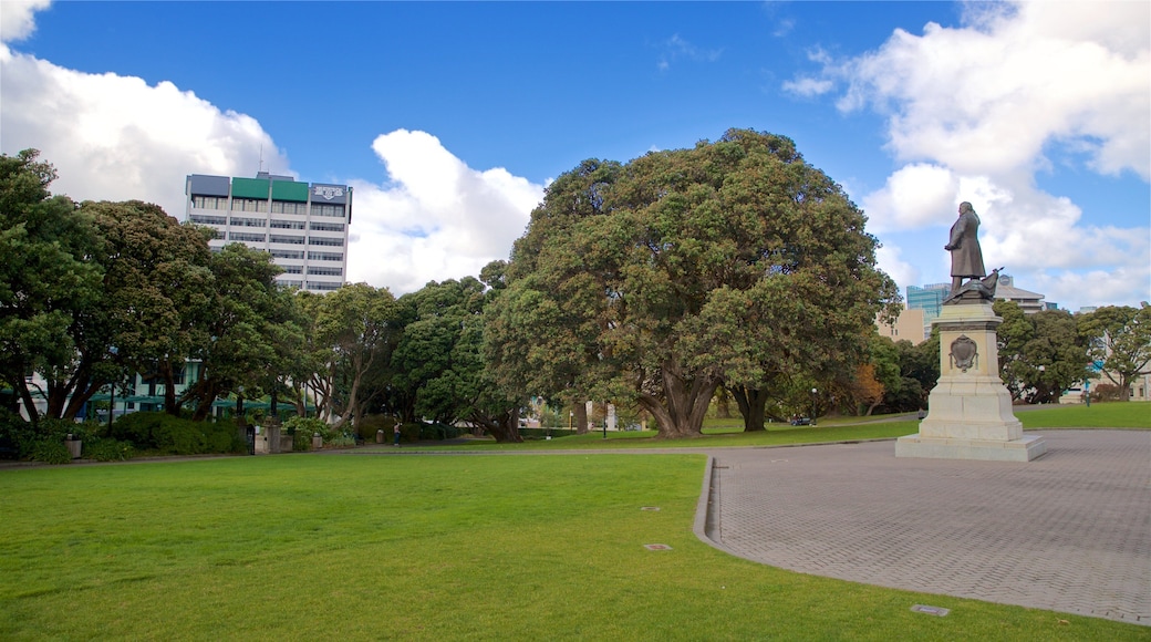 Parliament House featuring a garden and a statue or sculpture
