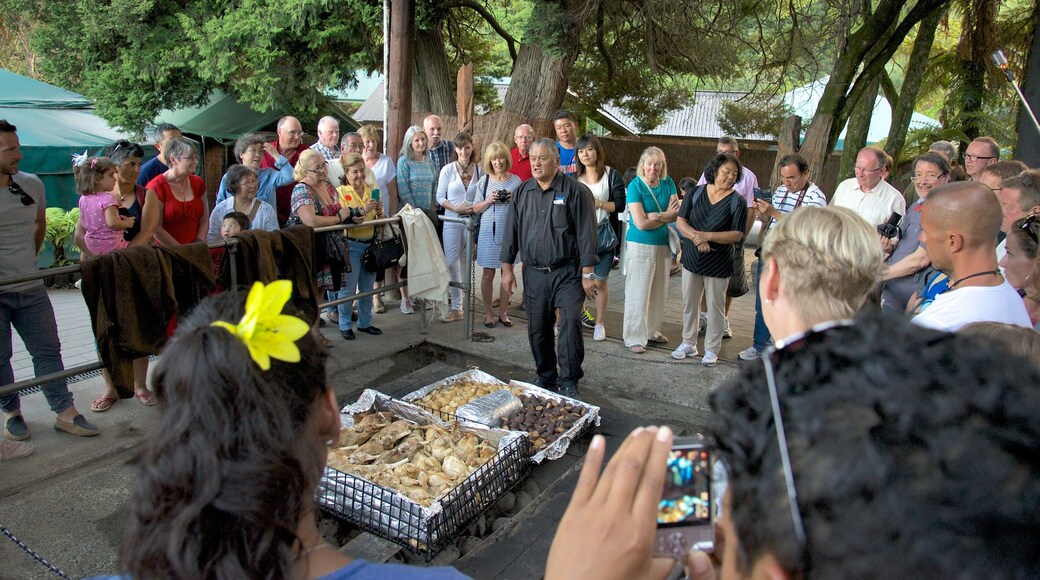 Rotorua featuring food as well as a large group of people