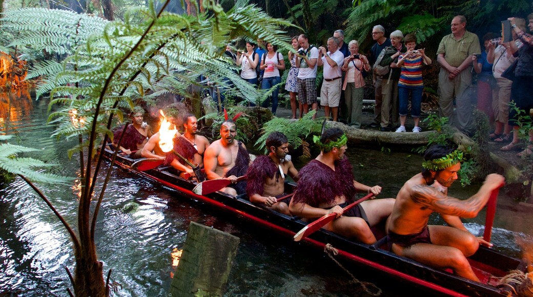 Rotorua featuring a river or creek and indigenous culture as well as a small group of people